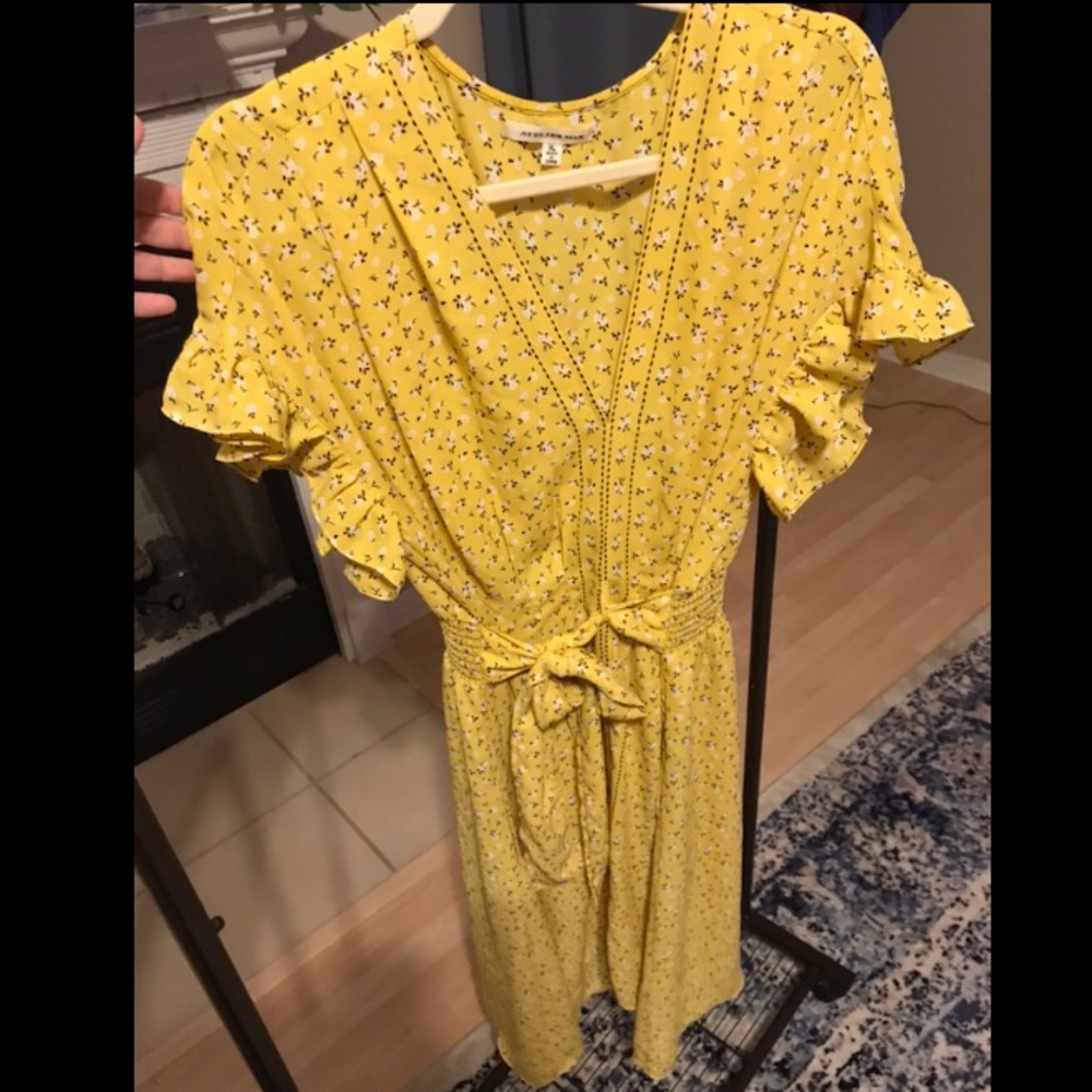 Yellow faux wrap dress with black detail.